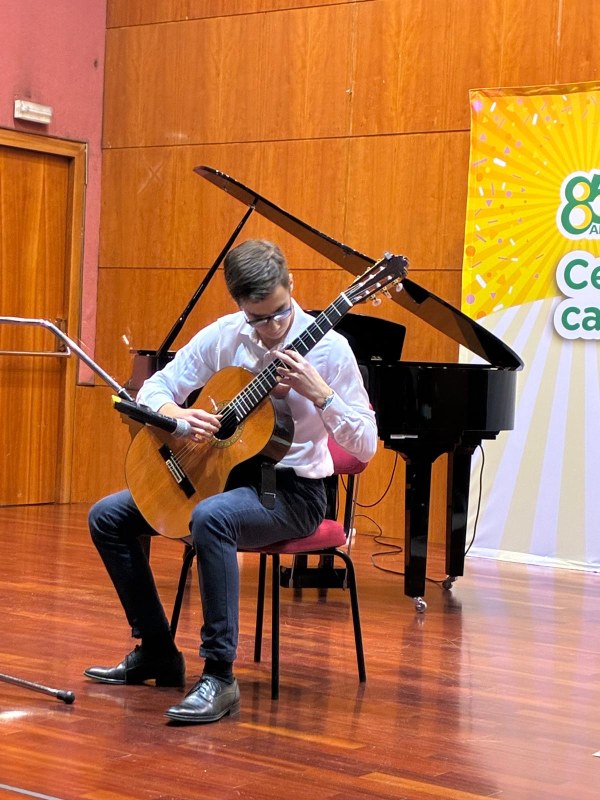 Hilario interpreta su obra a la guitarra