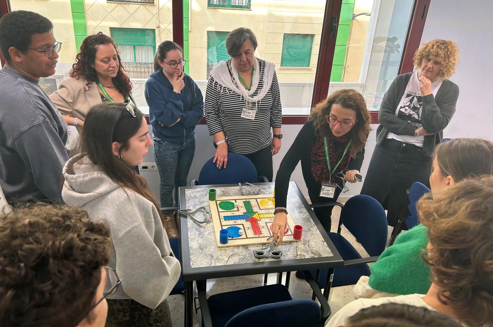 GRUPO DE ESTUDIANTES CON UN PARCHÍS ADAPTADO